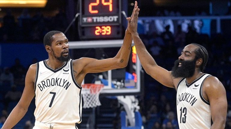 Nets forward Kevin Durant (7) and guard James Harden (13)...