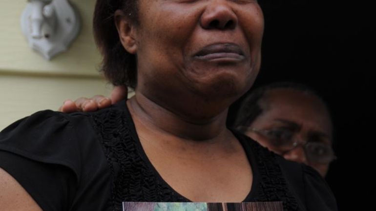 Evelyn Lindor, clutches a photo of her son, Tre'Zon P'Lindor,...