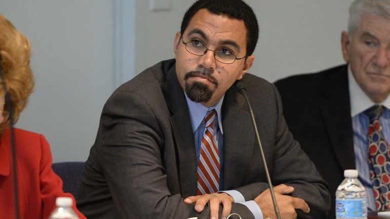 New York State Education Commissioner John B. King Jr. listens...