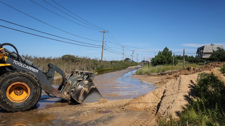 Crews from the Town of Southampton moved sand into mounds...