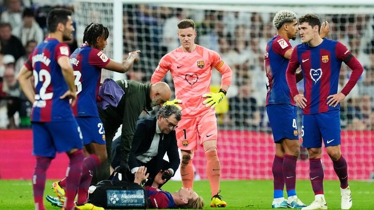 Barcelona's Frenkie de Jong lays injured during the Spanish La...