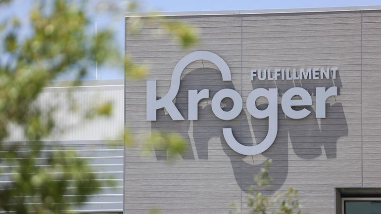 Trucks wait outside Kroger's fulfillment center, July 27, 2022 in...