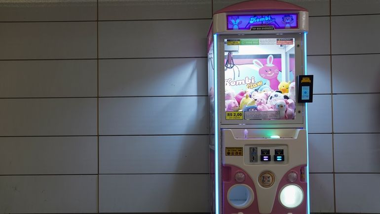 A claw machine sits inside a metro station in Rio...