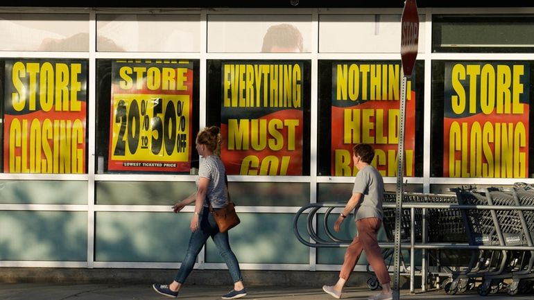 Shoppers enter exit a Bed Bath & Beyond store Monday,...