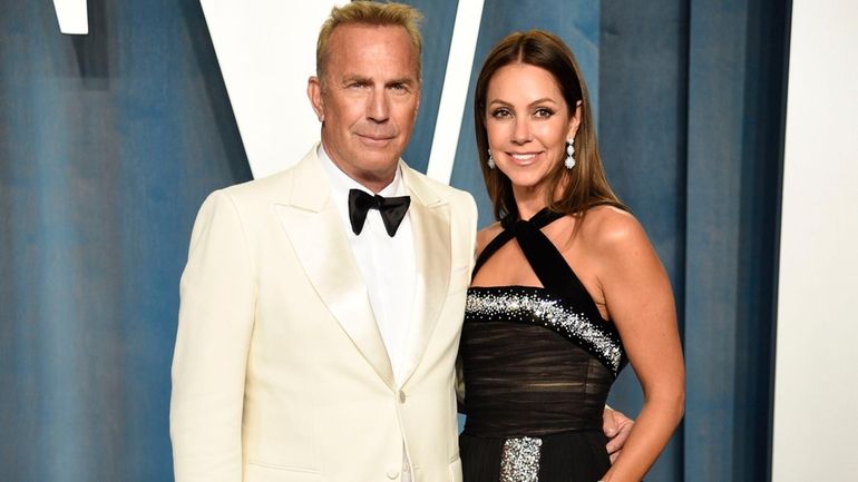 Kevin Costner, left, and Christine Baumgartner arrive at the Vanity...