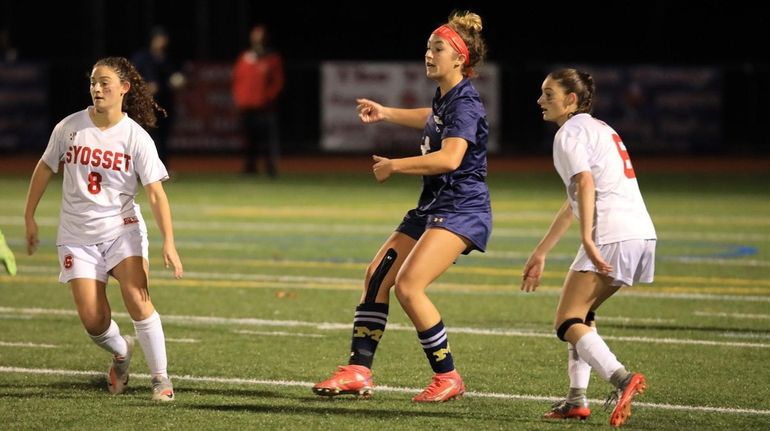 Syosset's Bella Romano, left, and Emma Romano, right, bracket Massapequa's...