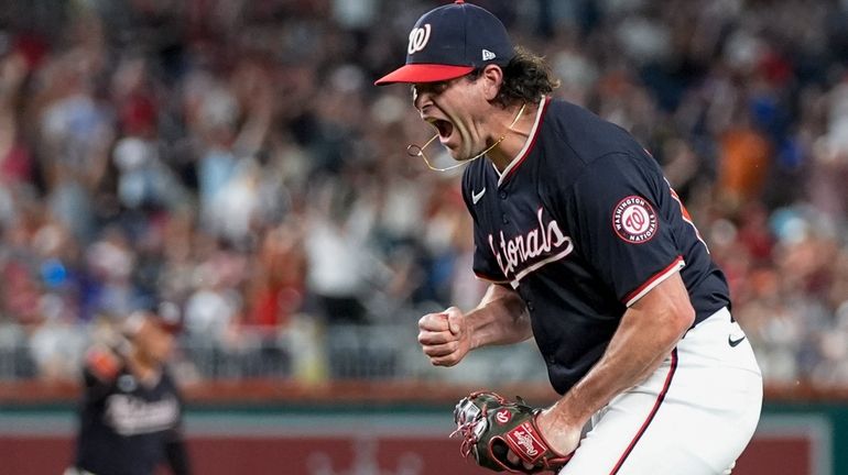 Washington Nationals pitcher Kyle Finnegan celebrates after the last out...