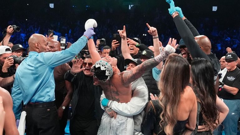 Ryan Garcia celebrates after winning a super lightweight boxing match...