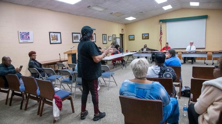 A member of the public addresses Wyandanch Public Library trustees at...