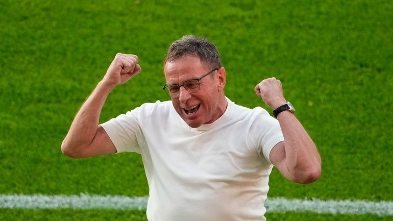 Austria's head coach Ralf Rangnick celebrates after their win in...
