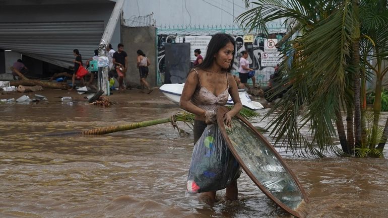 A woman walks away with stuff she took from a...