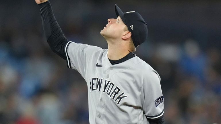 Yankees starting pitcher Michael King motions for a catch as...