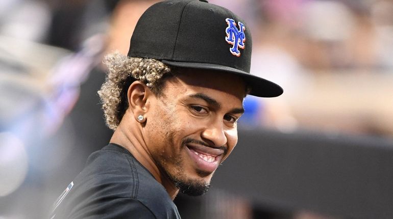 Mets' Francisco Lindor looks on from the dugout against the...