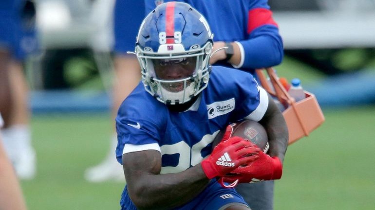 Giants wide receiver Kadarius Toney runs with the ball during training...