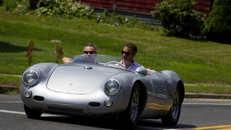 Bloomberg automotive critic Jason Harper, right, test drives a replica...