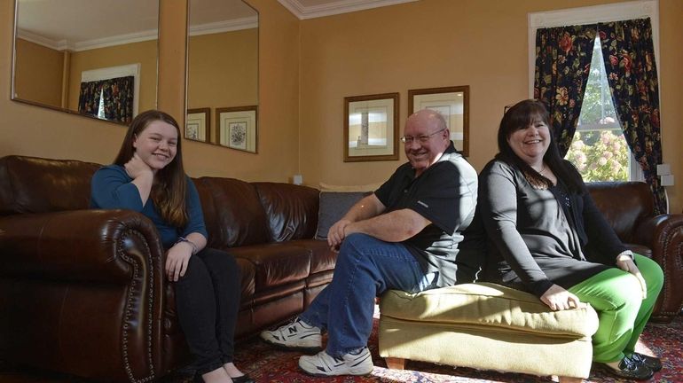 Jim and Maureen O'Brien sit with their daughter, Caroline, 13,...