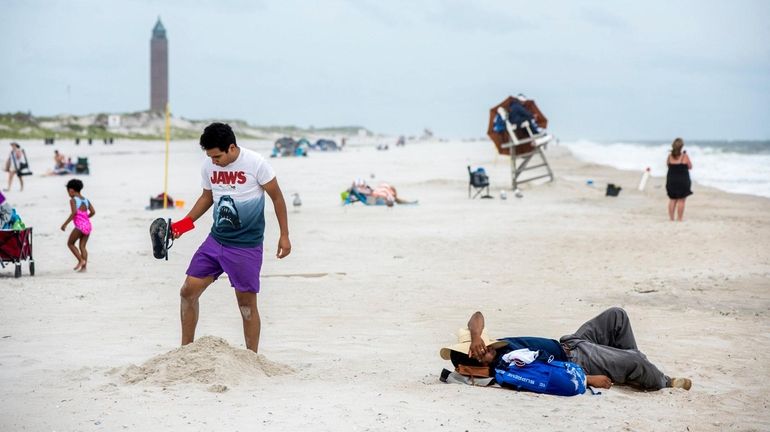 A beachgoer digs a hole at field 2, after some...