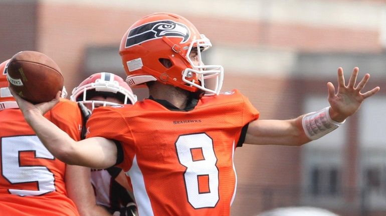 Dan Conte #8 of the Carey throws a pass against...