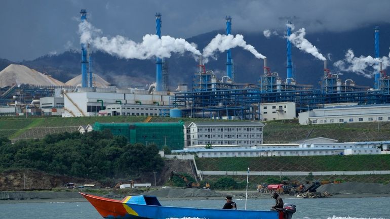 A boat cruises past the Indonesia Weda Bay Industrial Park...