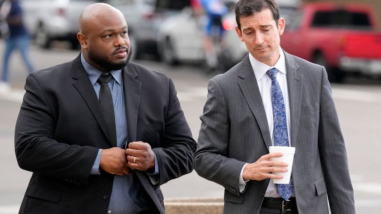 Former Memphis police officer Desmond Mills, left, arrives at the...