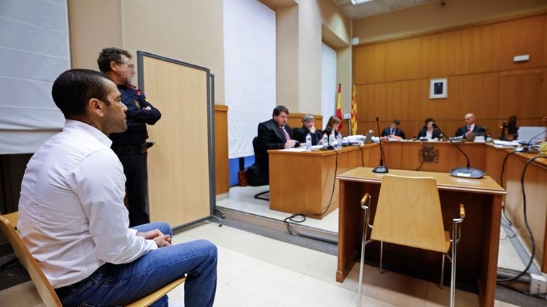 Brazilian soccer star Dani Alves sits during his trial in...