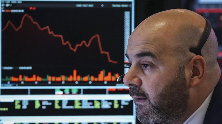 A trader watches the market on the floor of the New...