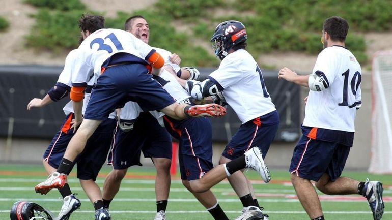 Manhasset boys lacrosse team celebrates their victory over Corning East...