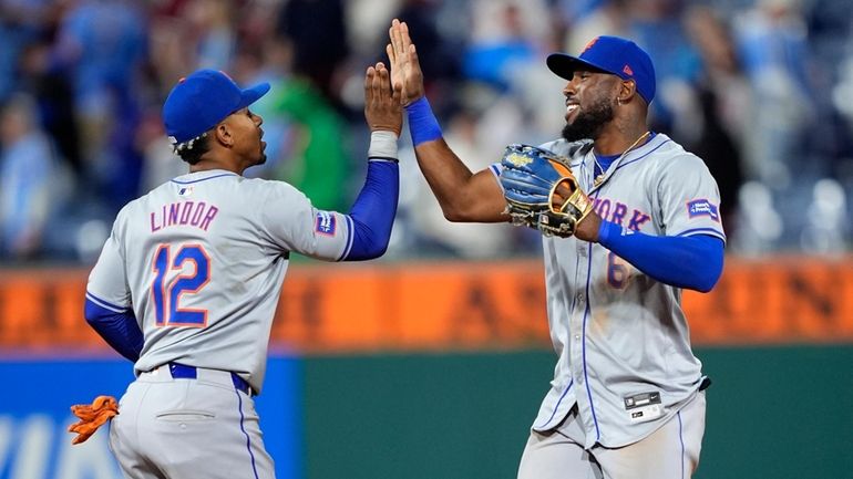 Mets' Francisco Lindor, left, and Starling Marte celebrate after the...