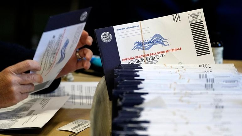 Chester County, Pa. election workers process mail-in and absentee ballots...