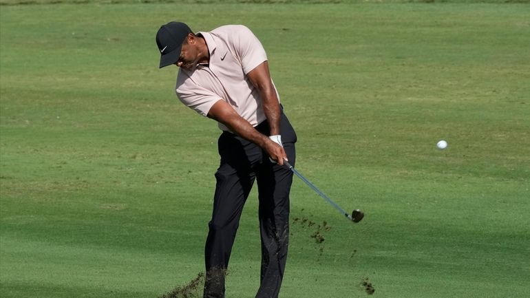 Tiger Woods hits from the first fairway during the first...