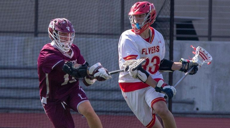 Chaminade's Will Kusnierek slides past St. Joseph's Hunter Parucki during...