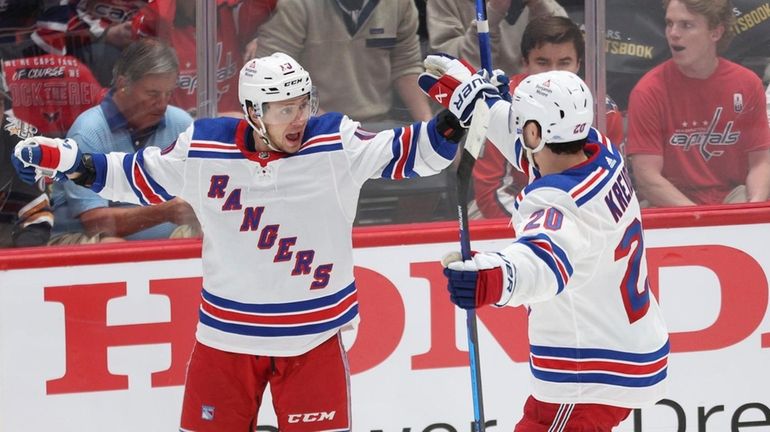 Artemi Panarin celebrates with Chris Kreider after scoring a goal...