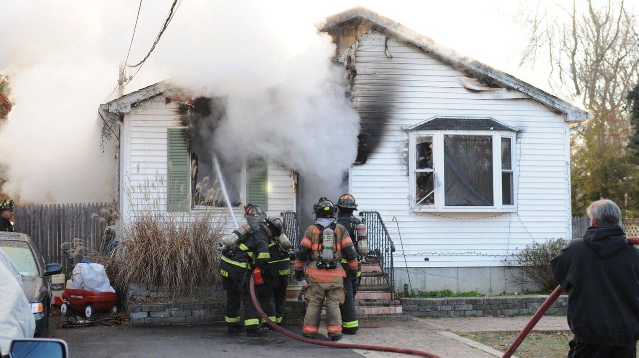 Two firefighters injured, dog dies in Shirley house fire, officials say