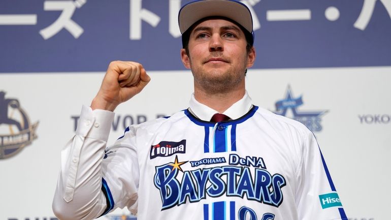 Trevor Bauer with his new uniform and cap of Yokohama...