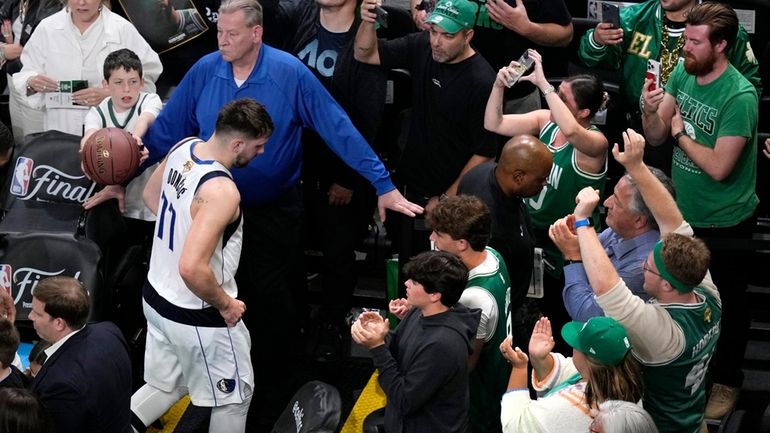 Dallas Mavericks guard Luka Doncic (77) heads to the locker...