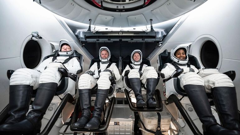 This photo provided by SpaceX shows, from left, Russian Aleksandr...