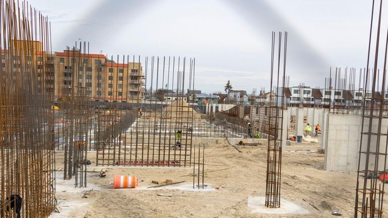 Construction crews work at the Long Beach Superblock site at...