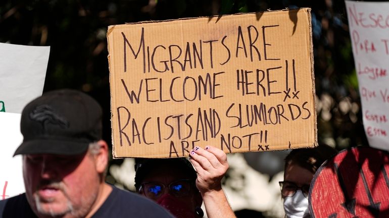 A protester holds up a placard during a rally staged...