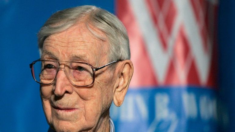 Former UCLA NCAA college basketball coach John Wooden listens during...