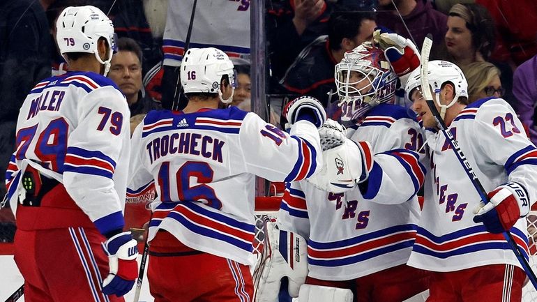 Rangers goaltender Igor Shesterkin (31), second right, is congratulated by...