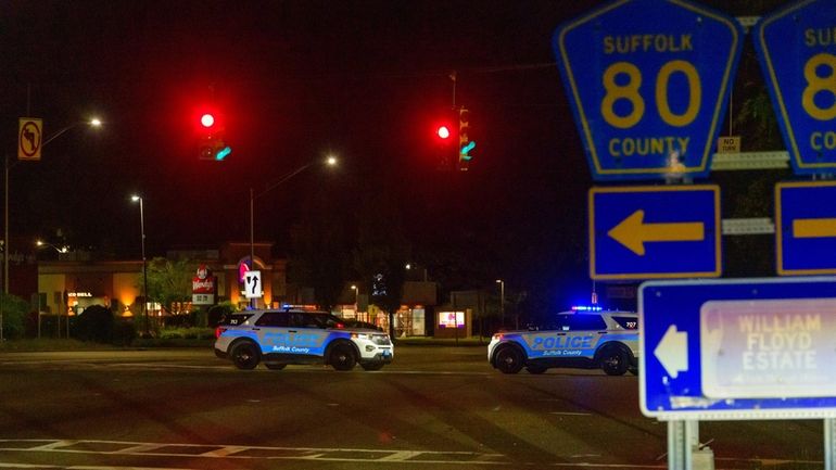 Two Suffolk police cars block southbound William Floyd Parkway at...