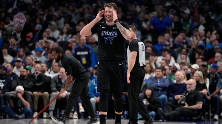 Dallas Mavericks guard Luka Doncic (77) smiles as he walks...