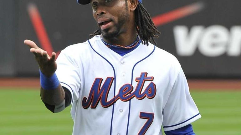 Mets shortstop Jose Reyes reacts to cheers from fans before...
