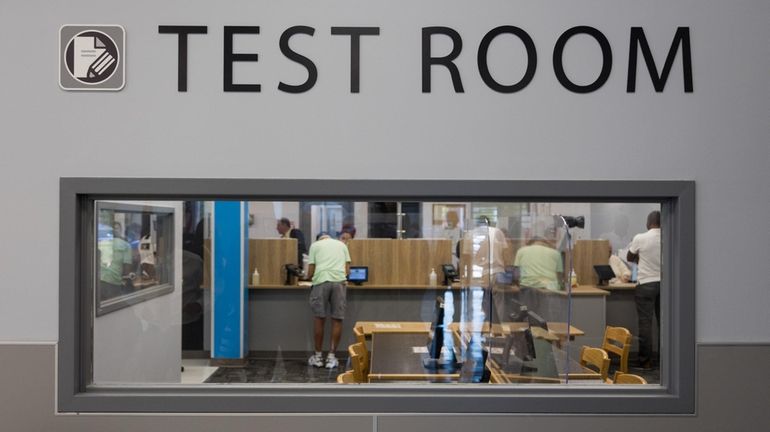 People fill out paperwork in the test room at the...