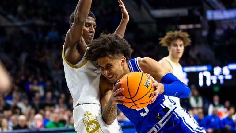 Duke's Tyrese Proctor (5) drives against Notre Dame's Markus Burton...