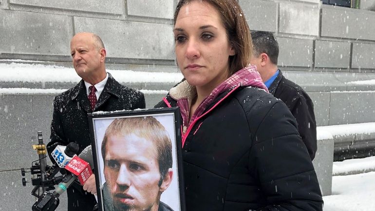 Trista Reynolds holds a picture of Justin DiPietro, estranged father...