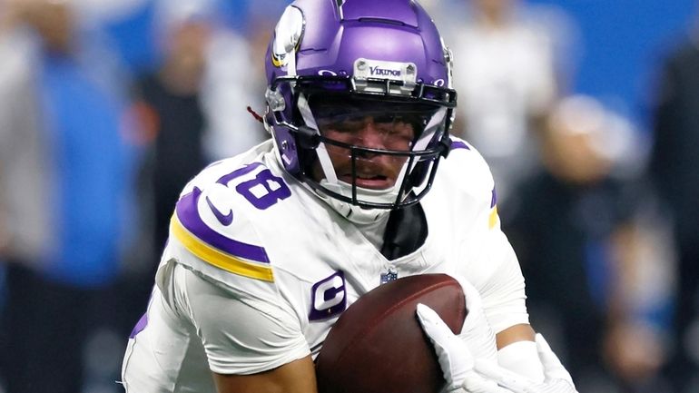 Minnesota Vikings wide receiver Justin Jefferson carries the ball against...