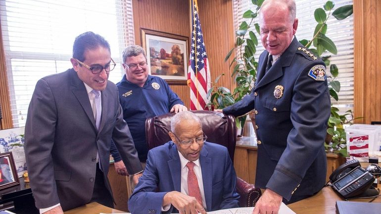 Hempstead Village Mayor Wayne Hall, center, and from left, Deputy...