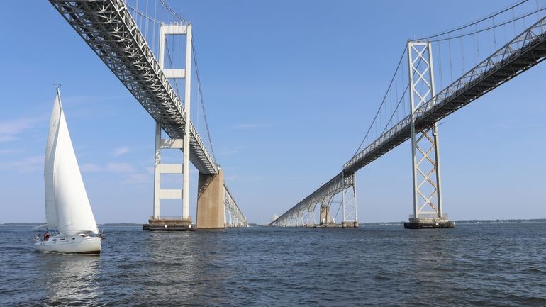 A boat sails on the Chesapeake Bay under the Bay...