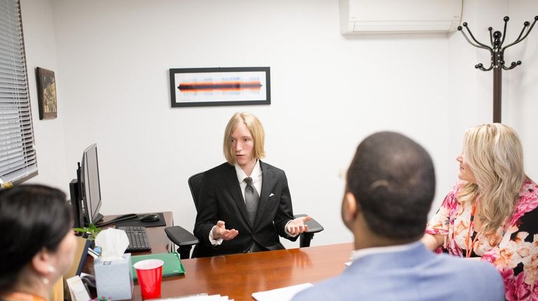 Adelphi University senior Richard Spiegel speaks with Northwell Health employees,...